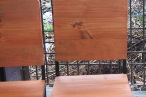 Um Par De Cadeiras De Madeira Sentadas Uma Ao Lado Da Outra 44ObbcP5XfE